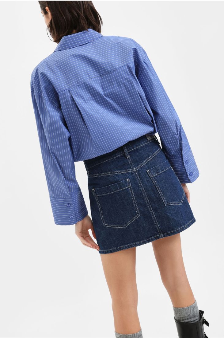 Denim mini skirt with asymmetric closure