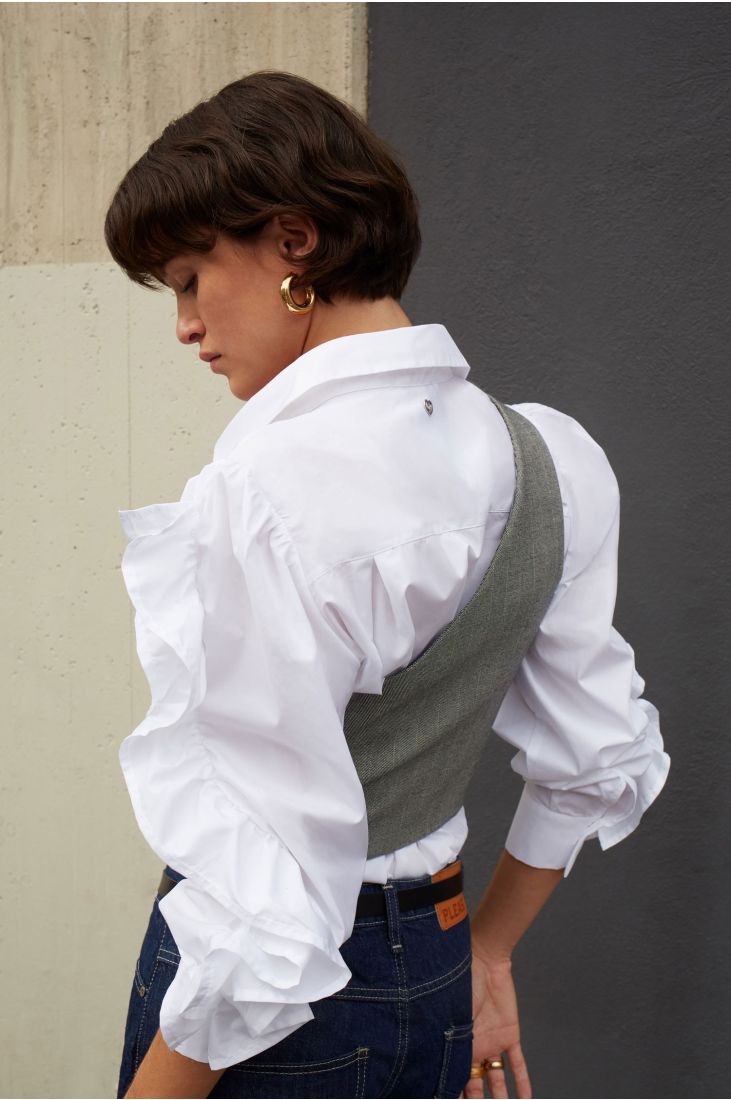 Asymmetrical vest with decorative buttons